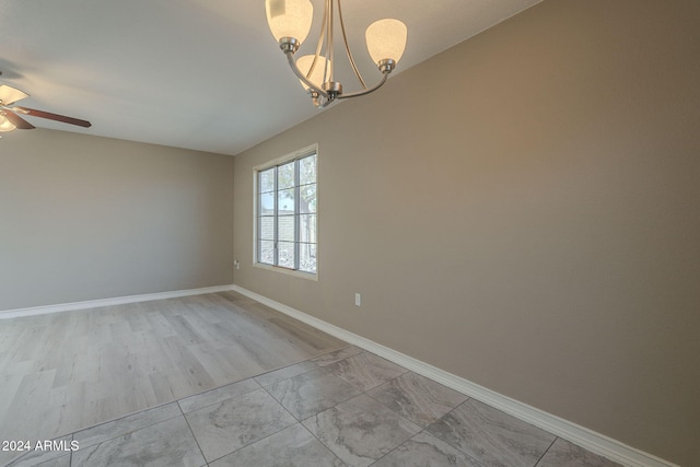 unfurnished room with light hardwood / wood-style flooring, vaulted ceiling, and a notable chandelier