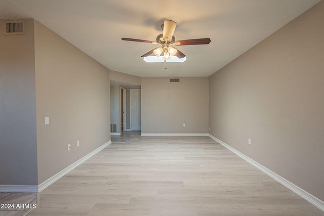 spare room with ceiling fan and light hardwood / wood-style flooring