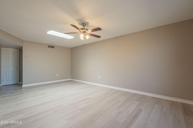 unfurnished room with ceiling fan and light wood-type flooring