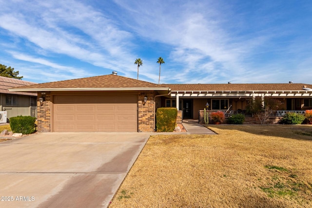 ranch-style house featuring a garage, a front yard, and covered porch