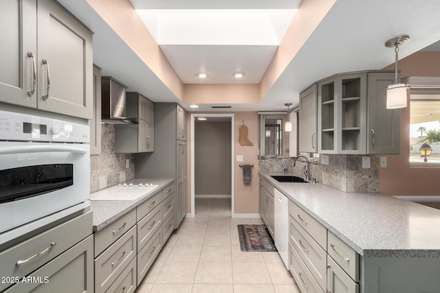 kitchen with sink, white appliances, tasteful backsplash, and light tile patterned flooring