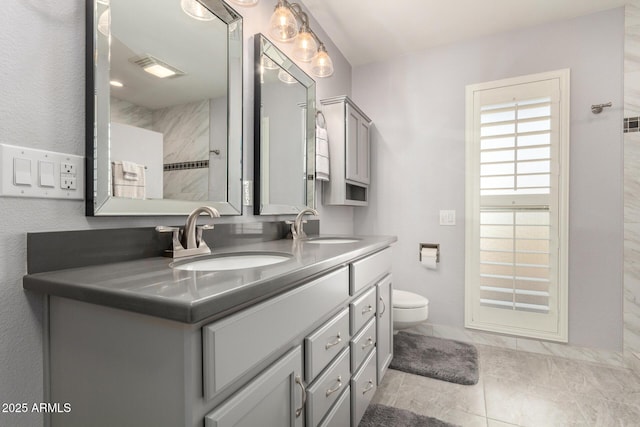 bathroom with vanity, toilet, and tile patterned floors