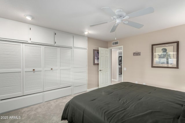 carpeted bedroom featuring a closet and ceiling fan