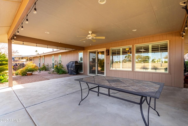 view of patio with ceiling fan and a grill