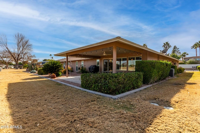 rear view of property featuring a patio area, ceiling fan, and central air condition unit