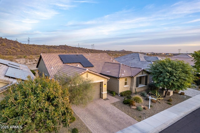 view of front of house with a garage and solar panels