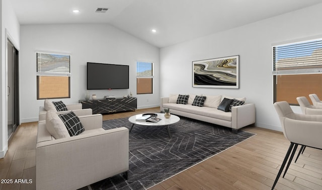 living room featuring vaulted ceiling, wood finished floors, baseboards, and recessed lighting