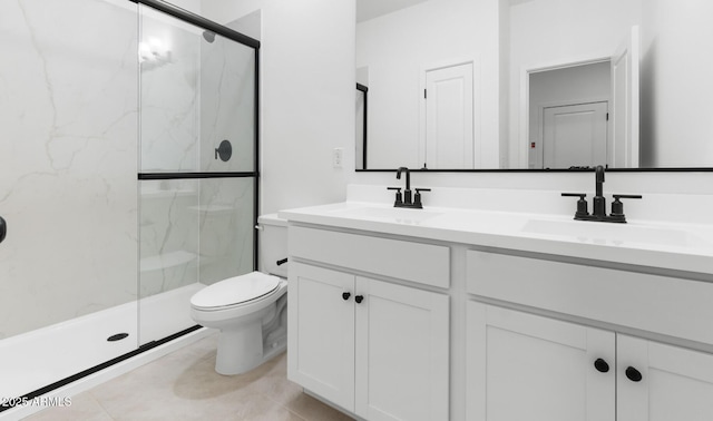 bathroom featuring a sink, double vanity, toilet, and a marble finish shower