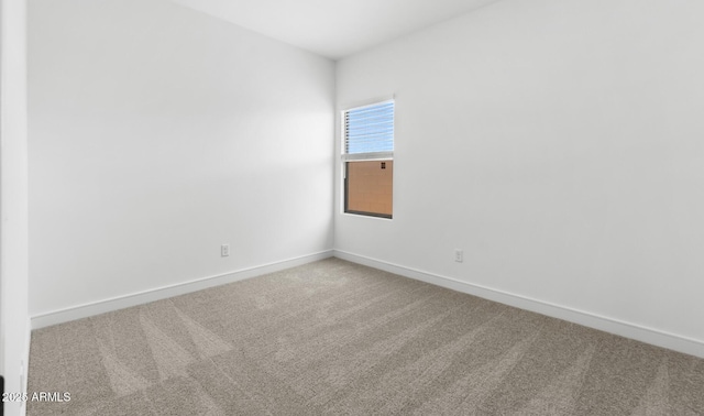 spare room with carpet floors and baseboards