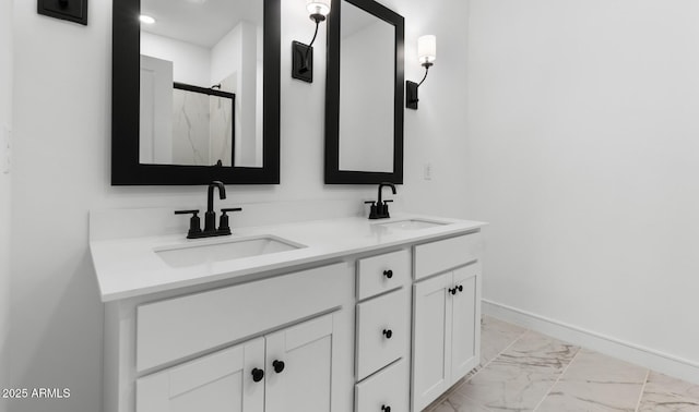 bathroom featuring double vanity, a marble finish shower, marble finish floor, and a sink