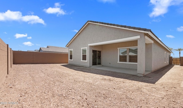back of property featuring a patio, stucco siding, and a fenced backyard
