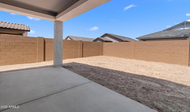 view of yard featuring a patio area and a fenced backyard