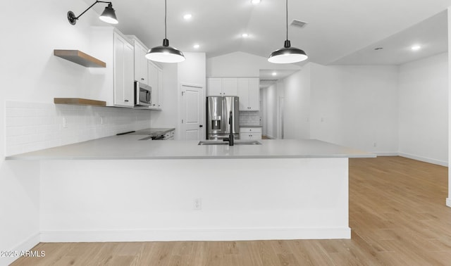 kitchen featuring open shelves, light countertops, visible vents, and appliances with stainless steel finishes