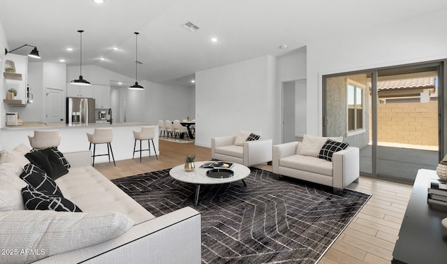 living room with vaulted ceiling, recessed lighting, visible vents, and light wood-style floors