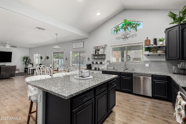 3545 W Tanner Ranch Rd, San Tan Valley, AZ 85144 - kitchen with stainless steel appliances, dark cabinets, a sink, a kitchen bar, and open floor plan