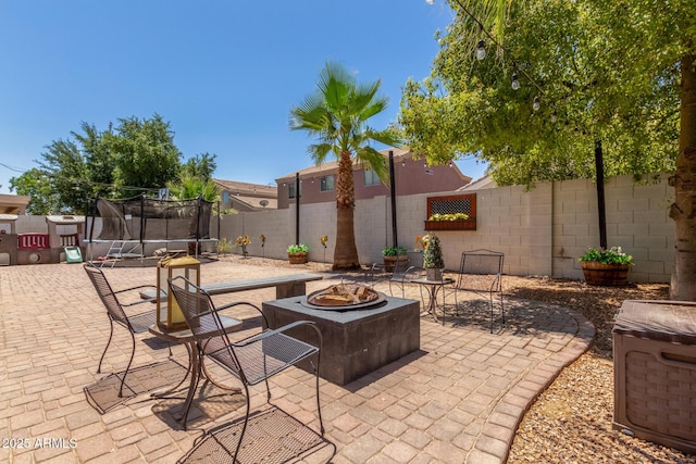 3545 W Tanner Ranch Rd, San Tan Valley, AZ 85144 - fenced backyard with a fire pit, a trampoline, and a patio area
