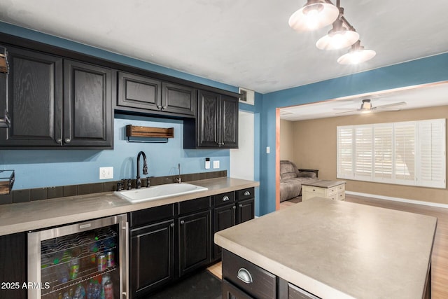 8331 N 6th St, Phoenix, AZ 85020 - kitchen with beverage cooler, open floor plan, dark cabinetry, light countertops, and wood finished floors
