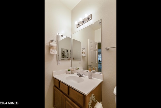 bathroom featuring toilet and vanity