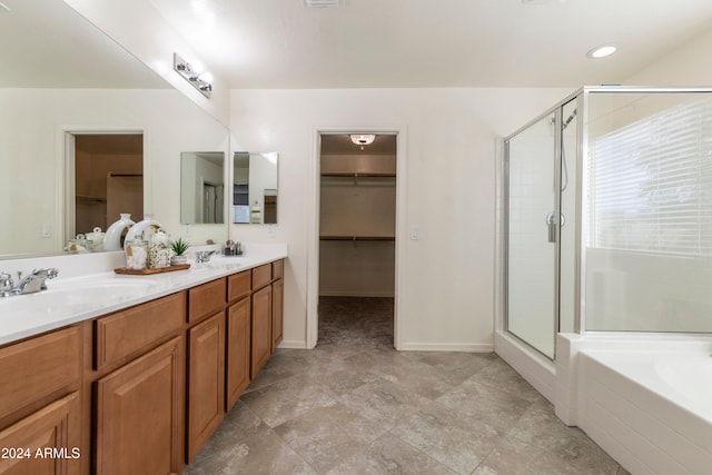 bathroom with vanity and shower with separate bathtub