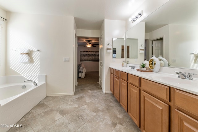 bathroom with vanity and tiled tub