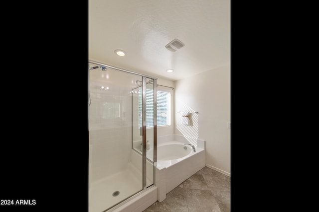 bathroom with tile patterned floors and independent shower and bath