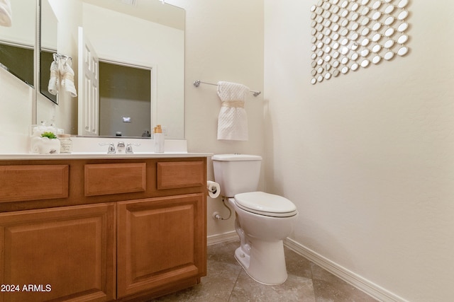 bathroom with vanity, toilet, and tile patterned floors