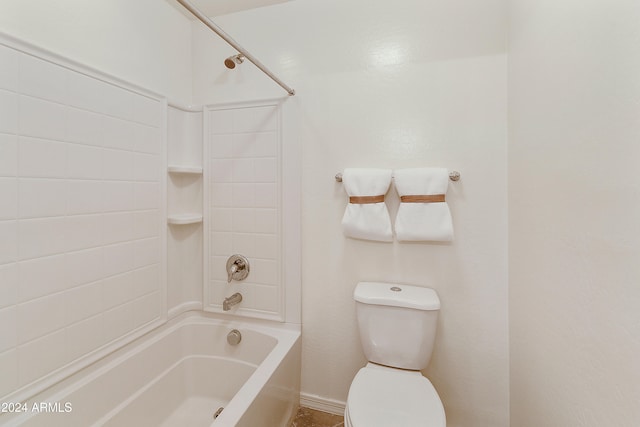 bathroom featuring toilet and tiled shower / bath combo