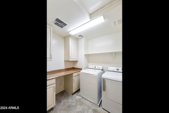 clothes washing area featuring cabinets and separate washer and dryer