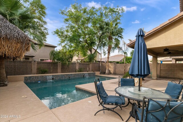 view of swimming pool with a patio, ceiling fan, and pool water feature