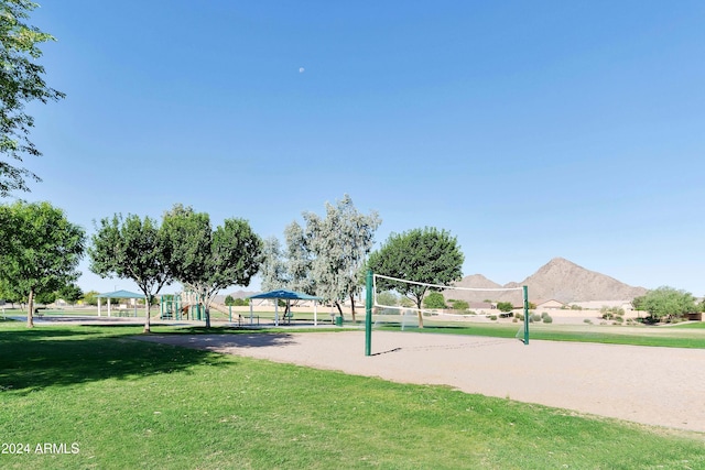 view of property's community with a gazebo, a lawn, and volleyball court