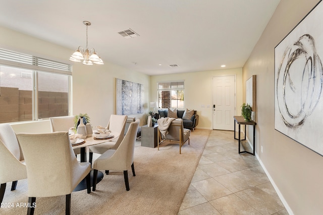 tiled dining area featuring an inviting chandelier