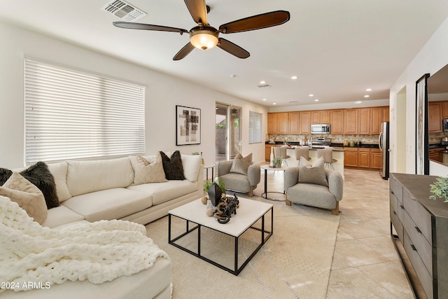 living room with light tile patterned floors and ceiling fan