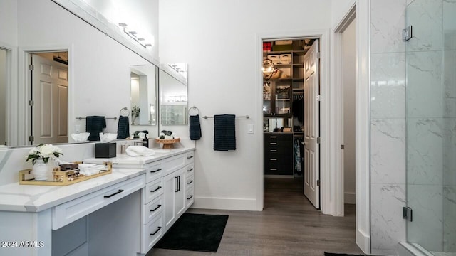 bathroom featuring hardwood / wood-style floors, vanity, and an enclosed shower