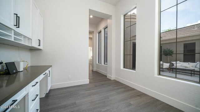 interior space with white cabinetry and dark hardwood / wood-style floors