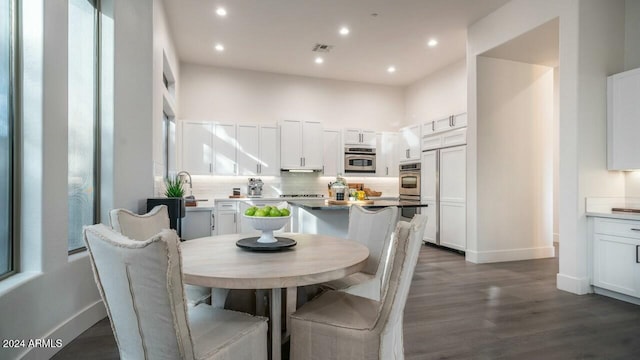 dining space with dark hardwood / wood-style flooring