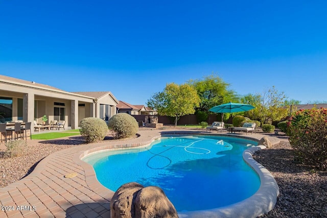 view of swimming pool with a patio area