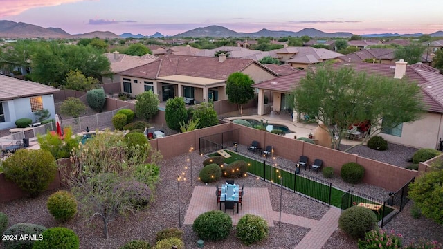 aerial view at dusk featuring a mountain view