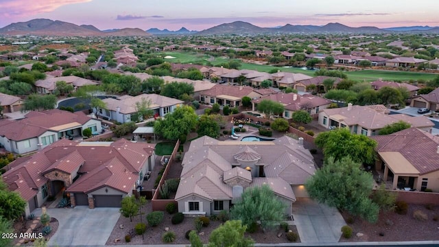 aerial view at dusk featuring a mountain view