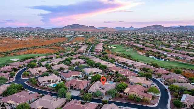 aerial view at dusk featuring a mountain view