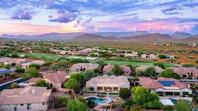 aerial view at dusk featuring a mountain view