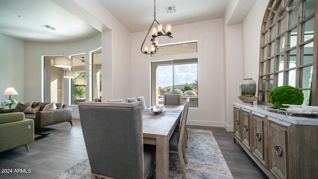 dining space with a chandelier and wood-type flooring