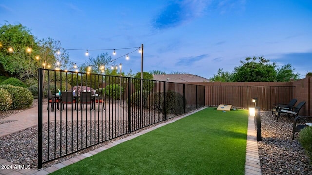 view of yard at dusk