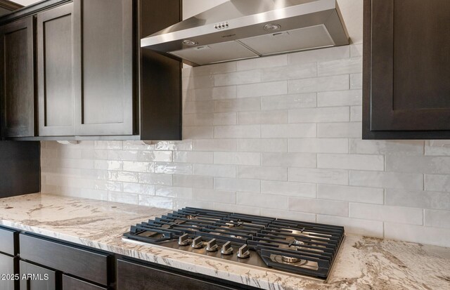 22523 E Orchard Ln, Queen Creek, AZ 85142 - kitchen featuring range hood, stainless steel gas stovetop, dark brown cabinets, and backsplash
