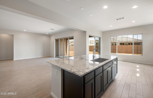 22523 E Orchard Ln, Queen Creek, AZ 85142 - kitchen with a sink, open floor plan, light wood-style flooring, a kitchen island with sink, and stainless steel dishwasher
