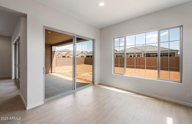 22523 E Orchard Ln, Queen Creek, AZ 85142 - unfurnished room with baseboards, plenty of natural light, wood finished floors, and recessed lighting