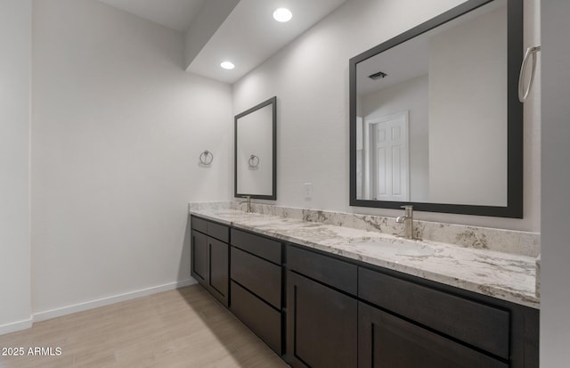 22523 E Orchard Ln, Queen Creek, AZ 85142 - bathroom with double vanity, wood finished floors, baseboards, and recessed lighting