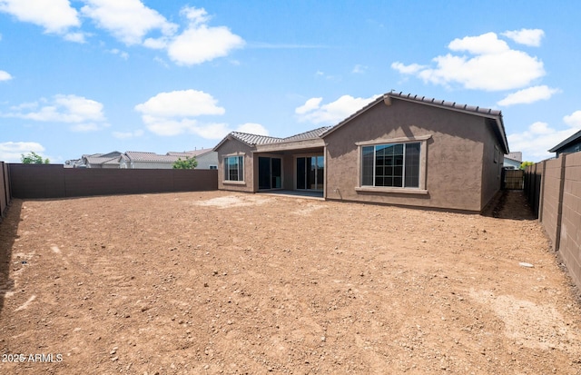 22523 E Orchard Ln, Queen Creek, AZ 85142 - back of property featuring a fenced backyard, stucco siding, a tiled roof, and a patio