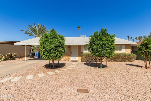 single story home featuring a carport and driveway