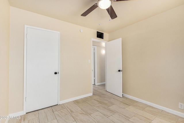 unfurnished bedroom featuring a ceiling fan, baseboards, and visible vents