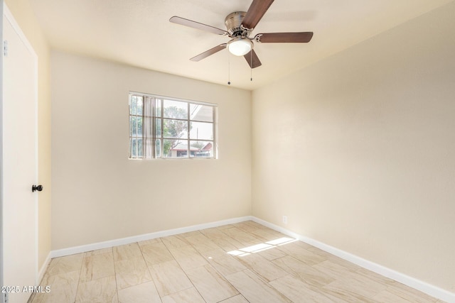 unfurnished room featuring a ceiling fan and baseboards